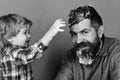 Cleaning and cleanliness. Man with beard and smiling child plays with soap suds. Royalty Free Stock Photo