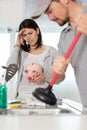 cleaning clogged pipes in kitchen sink with plunger Royalty Free Stock Photo