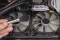 Cleaning the computer video card from dust with a brush and air. Computer fans in dust Royalty Free Stock Photo