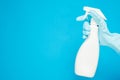 Cleaning concept, Hand in rubber gloves and holding spray bottle isolated on light blue background Royalty Free Stock Photo