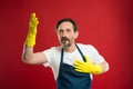 Cleaning day today. Bearded guy cleaning home. On guard of cleanliness and order. Cleaning service and household duty Royalty Free Stock Photo