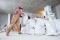 Worker collecting construction waste in bag Royalty Free Stock Photo