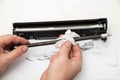 Cleaning the details of the laser cartridge printer from the remnants of the old toner on a white background. Refilling the Toner Royalty Free Stock Photo