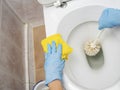 Cleaning a dirty home toilet with a brush and cleaning products