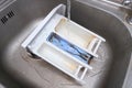 Cleaning dirty moldy washing machine detergent and fabric conditioner dispenser drawer compartment. Mold, rust and limescale in