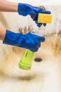 Cleaning dirty old bathtub with mould and corrosion indoors