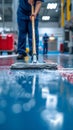 Cleaning epoxy floor service staff using a mop in uniform Royalty Free Stock Photo