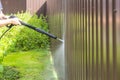 Cleaning fence with high pressure power washer, cleaning dirty wall