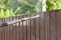 Cleaning fence with high pressure power washer, cleaning dirty wall