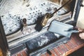 Cleaning fireplace with open tray.