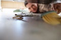 Cleaning the floor, doing chores and sweeping dust or dirt from under a bed. Domestic worker, maid or stay at home mom Royalty Free Stock Photo