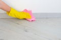 Cleaning floor in room close up. Woman cleaning parquet floor with rag at home. Housework and housekeeping concept Royalty Free Stock Photo