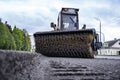 Cleaning of garbage from the road. a rotating mechanical machine brush