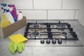 Cleaning a gas stove with kitchen utensils, household concepts, or hygiene and cleaning Royalty Free Stock Photo
