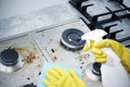 Cleaning a gas stove with kitchen utensils, household concepts, or hygiene and cleaning Royalty Free Stock Photo