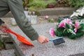 Cleaning grave on cemetery before All Saints` Day