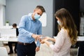 Cleaning Hands At Office Entrance Using Sanitizer