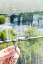 Cleaning of home window glass by squeegee