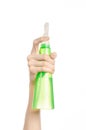 Cleaning the house and cleaner theme: man's hand holding a green spray bottle for cleaning isolated on a white background Royalty Free Stock Photo
