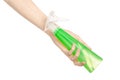 Cleaning the house and cleaner theme: man's hand holding a green spray bottle for cleaning isolated on a white background Royalty Free Stock Photo