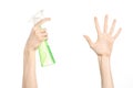 Cleaning the house and cleaner theme: man's hand holding a green spray bottle for cleaning isolated on a white background Royalty Free Stock Photo