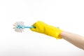 Cleaning the house and cleaning the toilet: human hand holding a blue toilet brush in yellow protective gloves isolated on a white Royalty Free Stock Photo