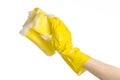 Cleaning the house and sanitation topic: Hand holding a yellow sponge wet with foam isolated on a white background in studio