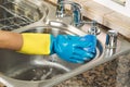 Cleaning inside of kitchen sink with soapy water and sponge Royalty Free Stock Photo