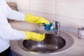 Cleaning kitchen sink and faucet Royalty Free Stock Photo