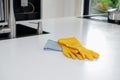 Cleaning in the kitchen. yellow glove rag on work surface