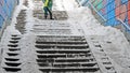 Cleaning ladder of snow and ice. Royalty Free Stock Photo