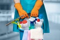 A cleaning lady with a bucket and cleaning products is standing Royalty Free Stock Photo