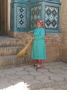 Cleaning lady in front of a religious building to Samarkand in Uzbekistan.