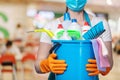 Cleaning lady in a mask with cleaning products Royalty Free Stock Photo