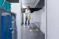 Cleaning lady mopping the floor in mens restroom Royalty Free Stock Photo