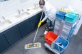 Cleaning lady mopping the floor in restroom Royalty Free Stock Photo