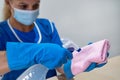 A cleaning lady prepares a cloth and agents for cleaning Royalty Free Stock Photo