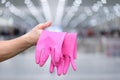 Cleaning lady shows rubber gloves Royalty Free Stock Photo