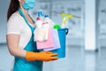 A cleaning lady is standing with a bucket and cleaning products Royalty Free Stock Photo