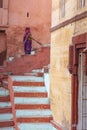 A Cleaning lady sweeps the street in front of her house in Varanasi