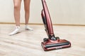 Cleaning lady vacuums with upright vacuum cleaner