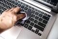 Cleaning the laptop keyboard with a napkin. Close up hand on a computer. Removing dust and killing bacteria to stay safe at home.