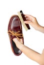 Cleaning leather shoes with a natural bristle brush. Shoe care. The work of a shoemaker. Royalty Free Stock Photo