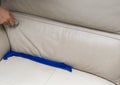 Cleaning leather sofa at home with sponge & towel Royalty Free Stock Photo