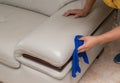 Cleaning leather sofa with towel Royalty Free Stock Photo