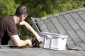 Cleaning leaves from the roof gutter Royalty Free Stock Photo