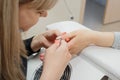 Cleaning and leveling the cuticle with nippers at the root of fingernails Royalty Free Stock Photo