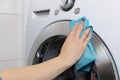 Cleaning and loading white washing machine Royalty Free Stock Photo