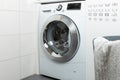 Cleaning and loading white washing machine Royalty Free Stock Photo