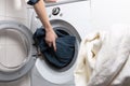 Cleaning and loading white washing machine Royalty Free Stock Photo